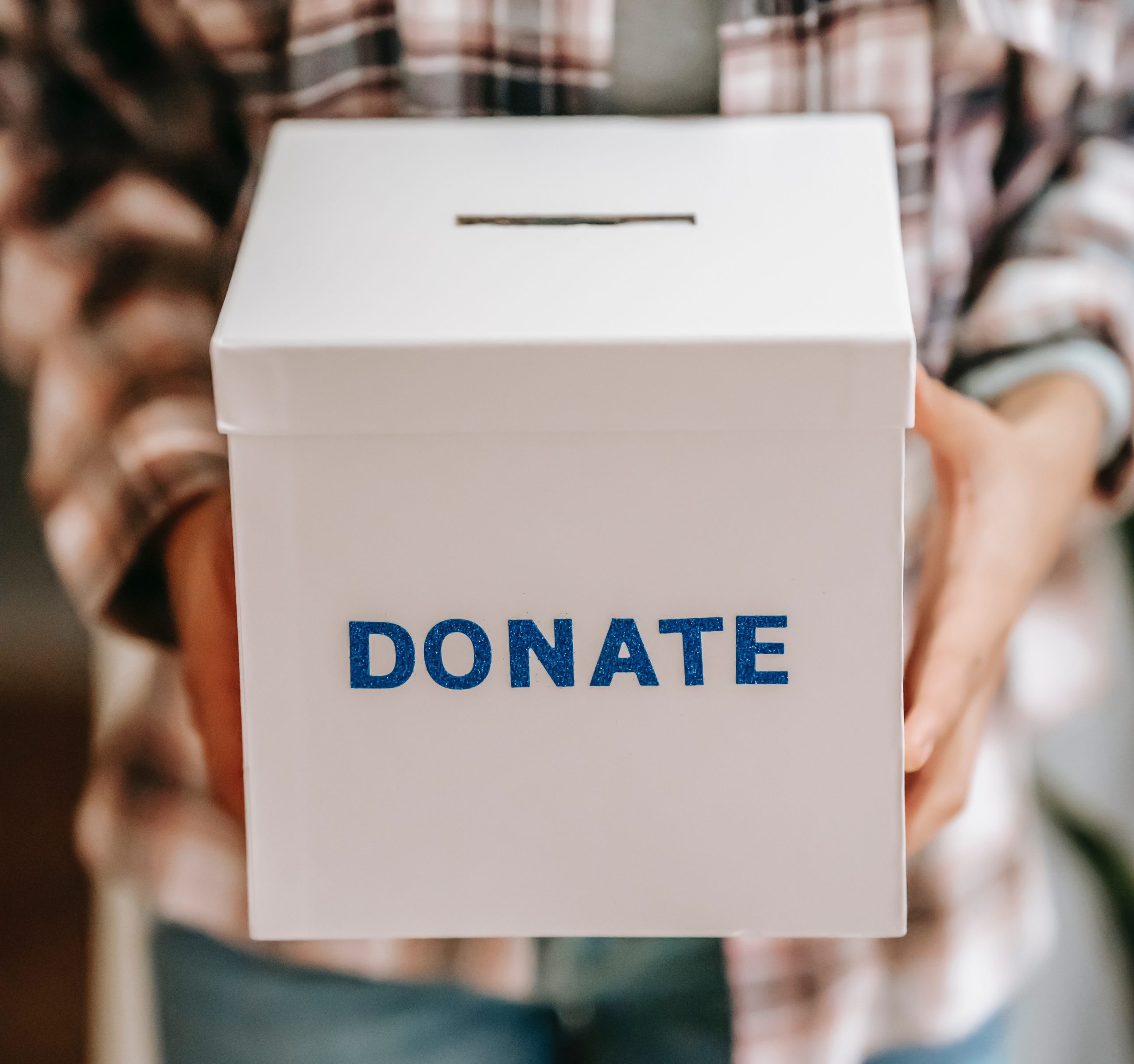 Person holding a donation box